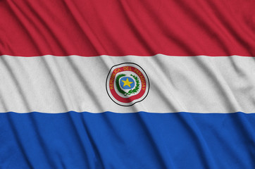 Paraguay flag  is depicted on a sports cloth fabric with many folds. Sport team banner