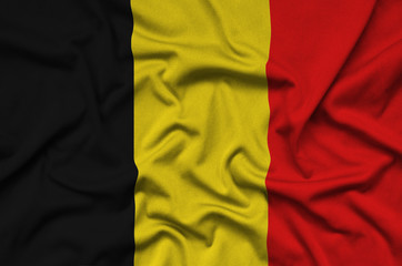 Belgium flag  is depicted on a sports cloth fabric with many folds. Sport team banner
