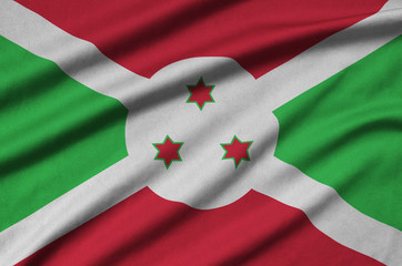 Burundi flag  is depicted on a sports cloth fabric with many folds. Sport team banner