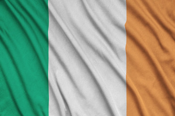 Ireland flag  is depicted on a sports cloth fabric with many folds. Sport team banner