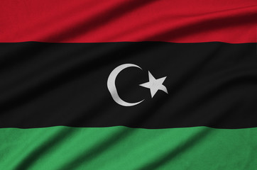 Libya flag  is depicted on a sports cloth fabric with many folds. Sport team banner