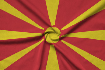 Macedonia flag  is depicted on a sports cloth fabric with many folds. Sport team banner