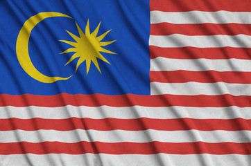 Malaysia flag  is depicted on a sports cloth fabric with many folds. Sport team banner
