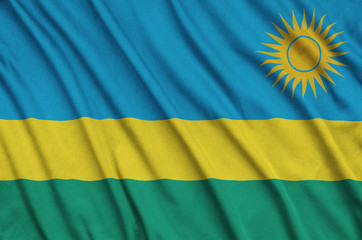 Rwanda flag  is depicted on a sports cloth fabric with many folds. Sport team banner