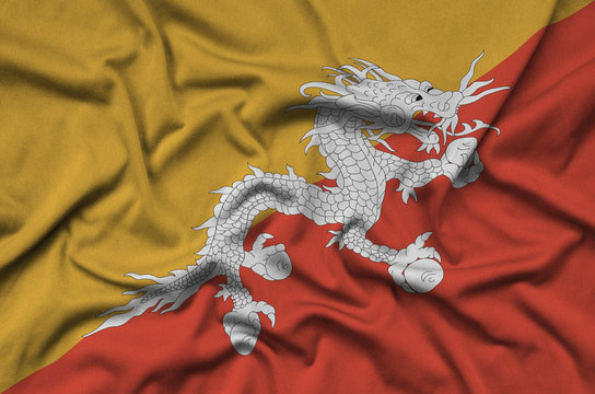 Bhutan flag  is depicted on a sports cloth fabric with many folds. Sport team banner