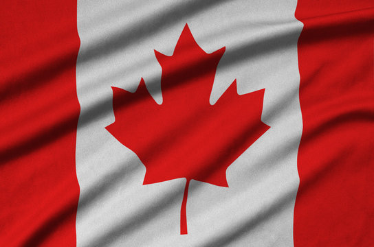 Canada flag  is depicted on a sports cloth fabric with many folds. Sport team banner