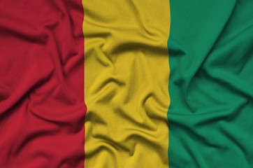 Guinea flag  is depicted on a sports cloth fabric with many folds. Sport team banner