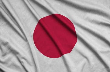 Japan flag  is depicted on a sports cloth fabric with many folds. Sport team banner