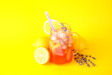 Red berry lavander lemonade, lemon and straw. Virgin strawberry mojito, non alcoholic cocktail with ice in vintage mason jar glass, Isolated on bright yellow background. Copy space, top view, close up
