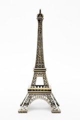 Fototapeta na wymiar miniature model of a golden Eiffel tower on a white background (mock-up)