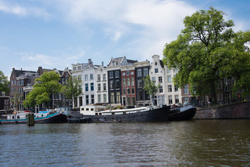 Dutch canal scene viewed from a tourist boat in Amsterdam in the Netherlands