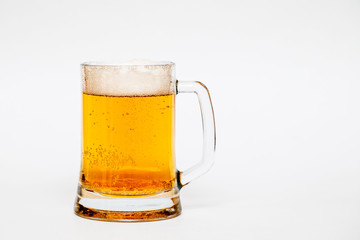 A glass of light beer on a white background.