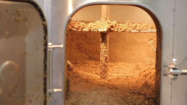 Brewing. Mixing of malt in the brewing tank. Used malt after brewing process.