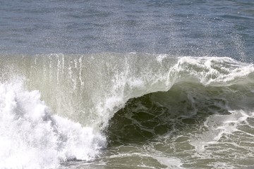 close up of wave breaking in the ocean 