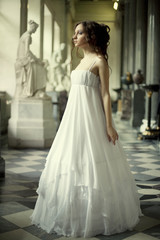 Fototapeta premium Portrait of a beautiful young victorian lady in white dress