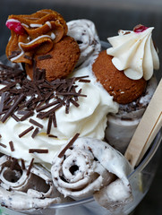 Roll ice cream is made by hand on the freezer. Sweet dessert made with biscuits and caramel syrup.