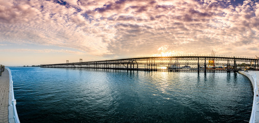 Panoramic view of landmark Riotinto pier in Huelva, Spain, at sunset