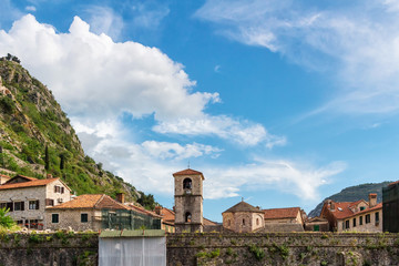 View to the city wall and old historical buildings with orange roofs in the ancient town Kotor at Montenegro