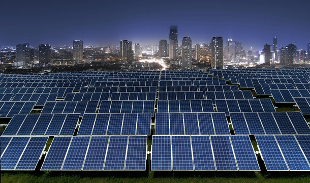 Solar power panels with city lights