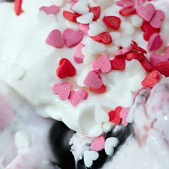 Fruit roll ice cream is decorated with caramel in the shape of heart.