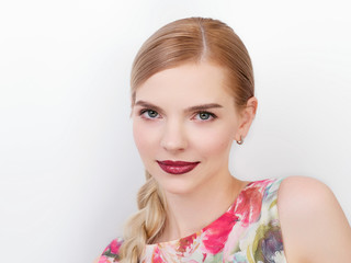 Fototapeta premium Beauty portrait of young beautiful cheerful young fresh looking woman with bright trendy make up blond healthy hair braid hairstyle.