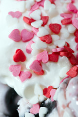 Fruit roll ice cream is decorated with caramel in the shape of heart.