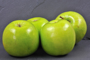 green apples on a slate plate
