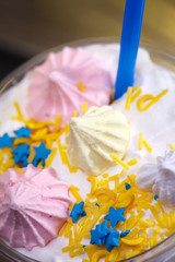 Decoration of a milkshake with confectionery. Cold sweet dessert.