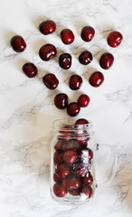 glass jar with cherries on the table