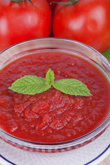 A bowl of mashed tomato with tomatoes