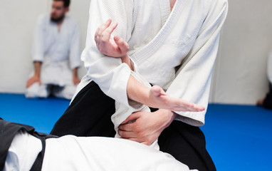 Obraz premium Aikidoka uses the technique joint lockon the opponent during the training of aikido