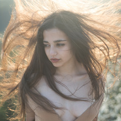 Hair like fire. Extremely sensual. Woman with long and healthy hair. Arabian woman with sexy cleavage. hairdresser salon. Glamour fashion girl on sunny outdoor