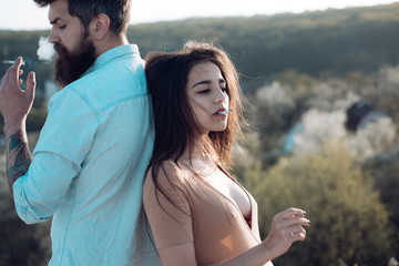 Bad habit and addiction. Man and woman with cigarettes. Smoking couple on natural landscape. Taking...