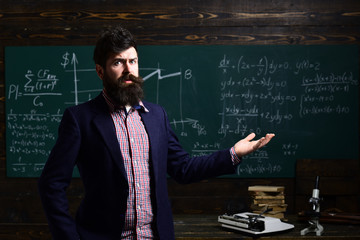 High school. University students studying with books in library. Successful student makes his studies priority. Teacher or tutor helps preschool child