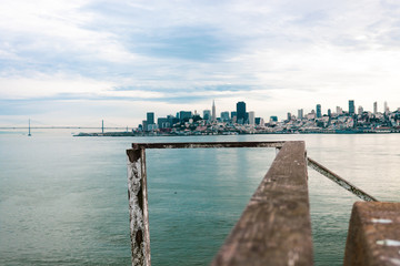 San Francisco Skyline from Alcatraz with weathered wooden handrail
