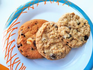 Chocolate chip and oatmeal raisin cookies on a plate - 210221264
