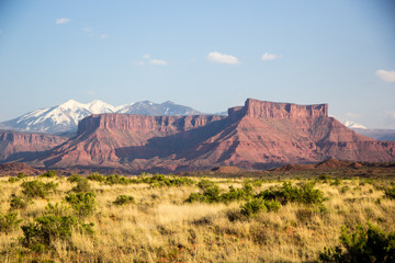 The Red Rock Monuments and White Capped Mountains of Moab Utah