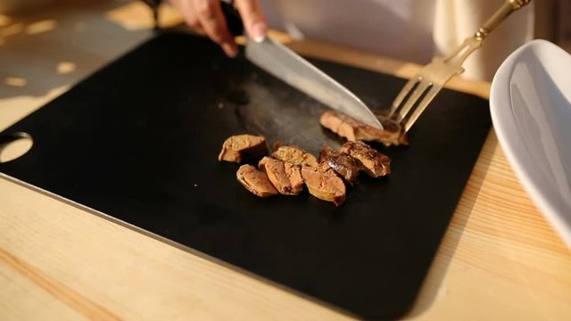 cutting a liver on a cutting board, close-up