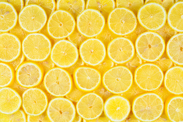 A slices of fresh juicy yellow lemons.  Texture background, pattern