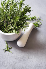 Fresh rosemary herb on a gray concrete background