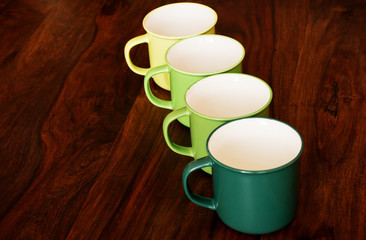 Colorful porcelain mug set on a wooden table