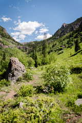 Green landscape view of Booth Falls hiking trail near Vail, Colorado. 