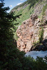 Water flowing over the edge of Booth Falls waterfall in Vail, Colorado. 