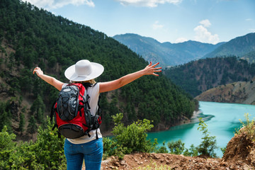 Woman traveler with backpack enjoying view