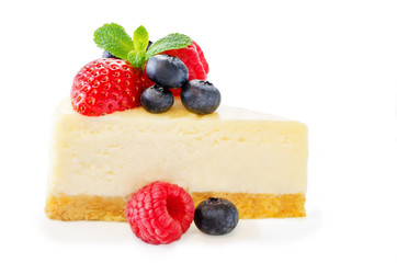 Cheesecake with fresh berries and mint leaves isolated