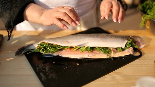Fresh raw trout with spices on a wooden board. The concept of healthy food and diet. Close-up.