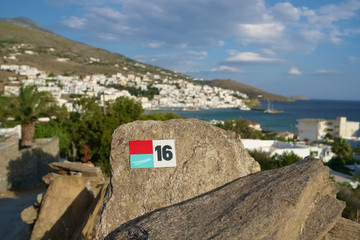 Hiking trail marker near the Batsi village on Andros island, Cyclades, Greece.