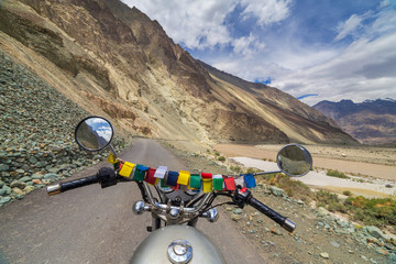 Motorcycling the Leh Manali Highway, a high altitude road that traverses the great Himalayan range, Ladakh, India. View from the rider side