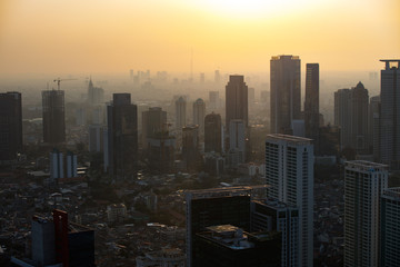Fototapeta na wymiar New Skyscrapers Dot The Skyline Of The Jakarta Skyline At Sunset