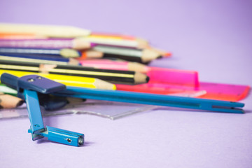 close-up of old broken compass on old colored pens